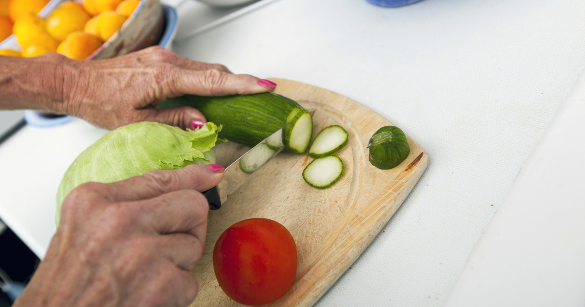 senior woman chopping vegetables