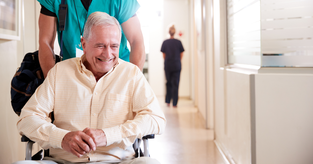 Happy Senior Man in Wheelchair after Hospital Stay