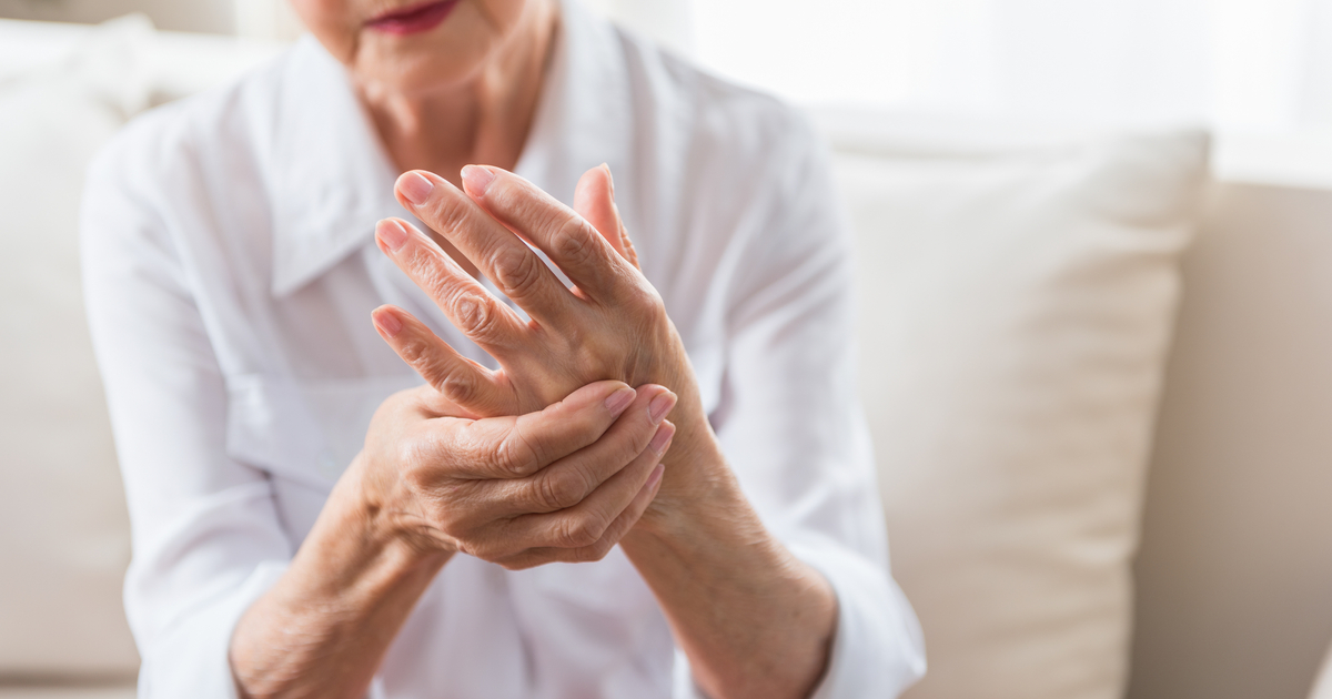 An elderly woman is dealing with the pain resulting from osteoarthritis