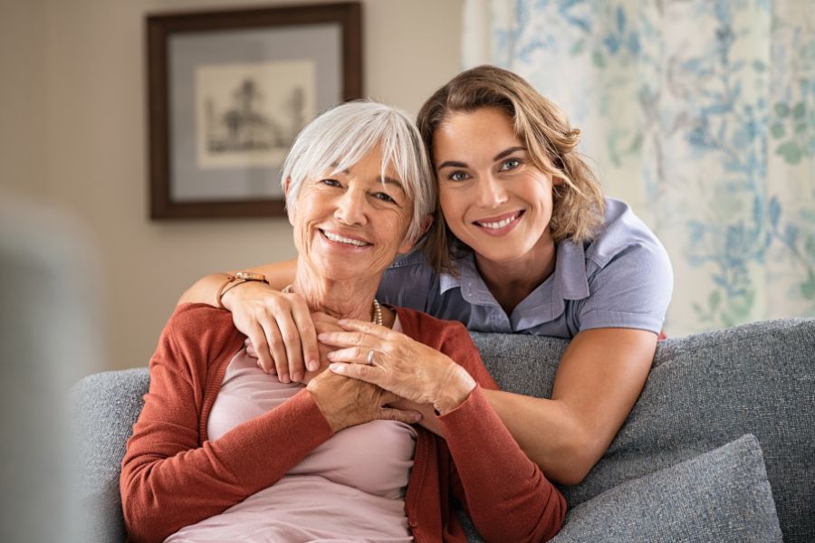 caregiver-hugging-elderly-woman woman with a caregiver