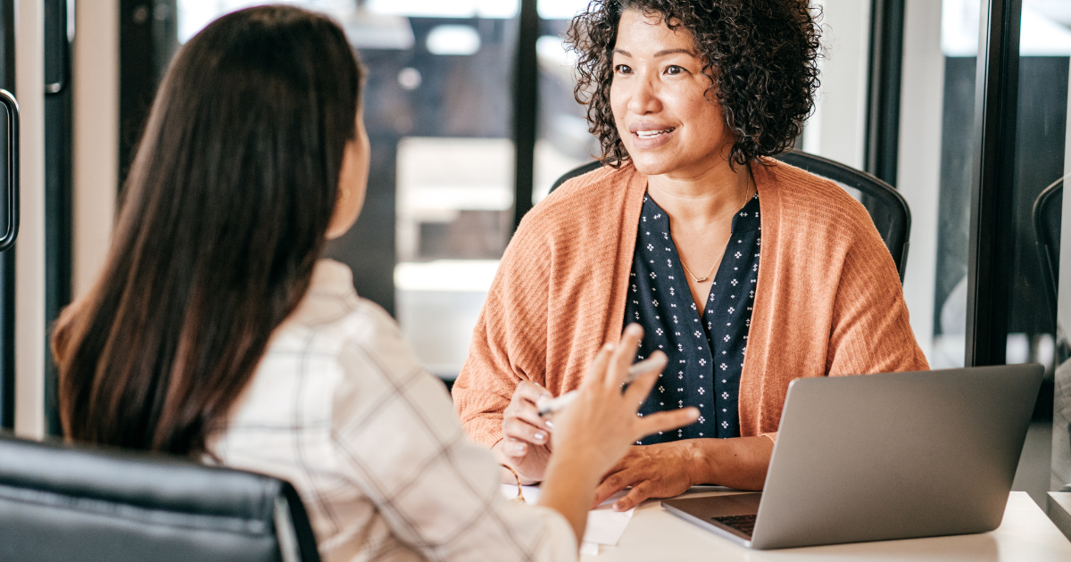 A woman interviews another woman for a caregiver job position.