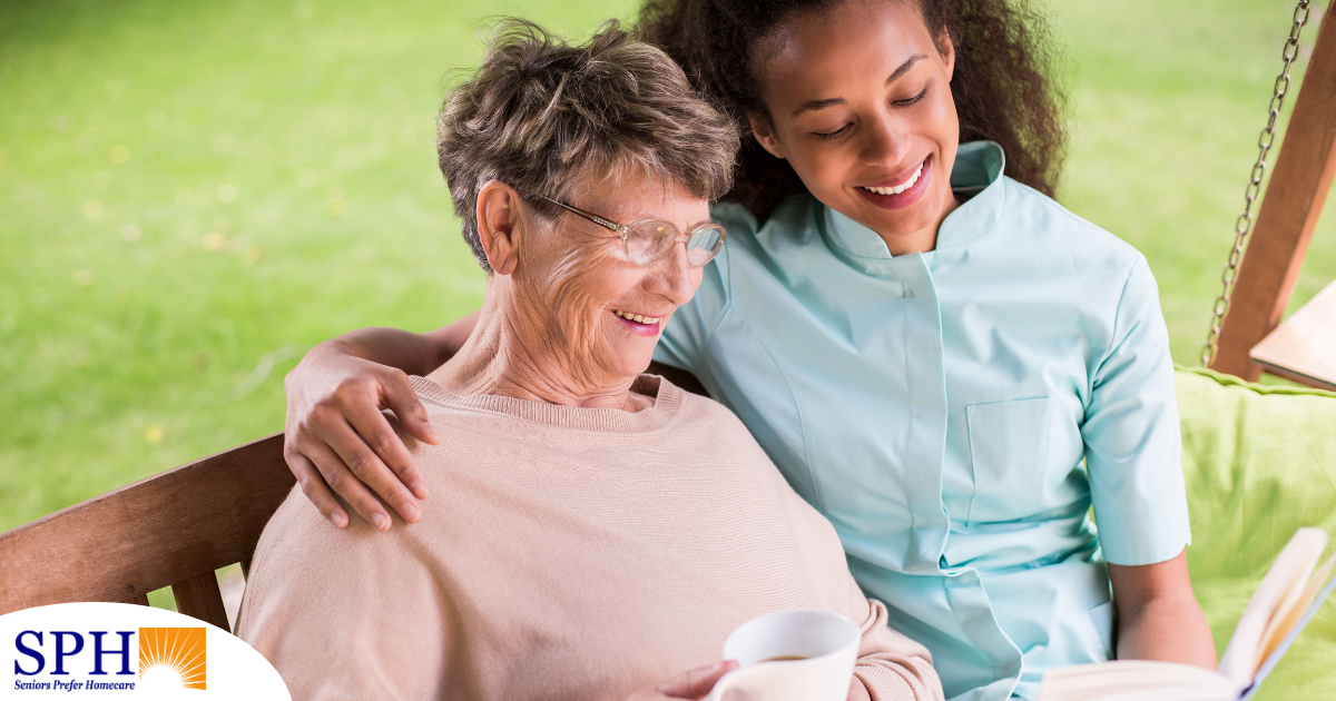 Professional caregivers like this one who is reading a book with a senior client can help them stay mentally active and engaged.