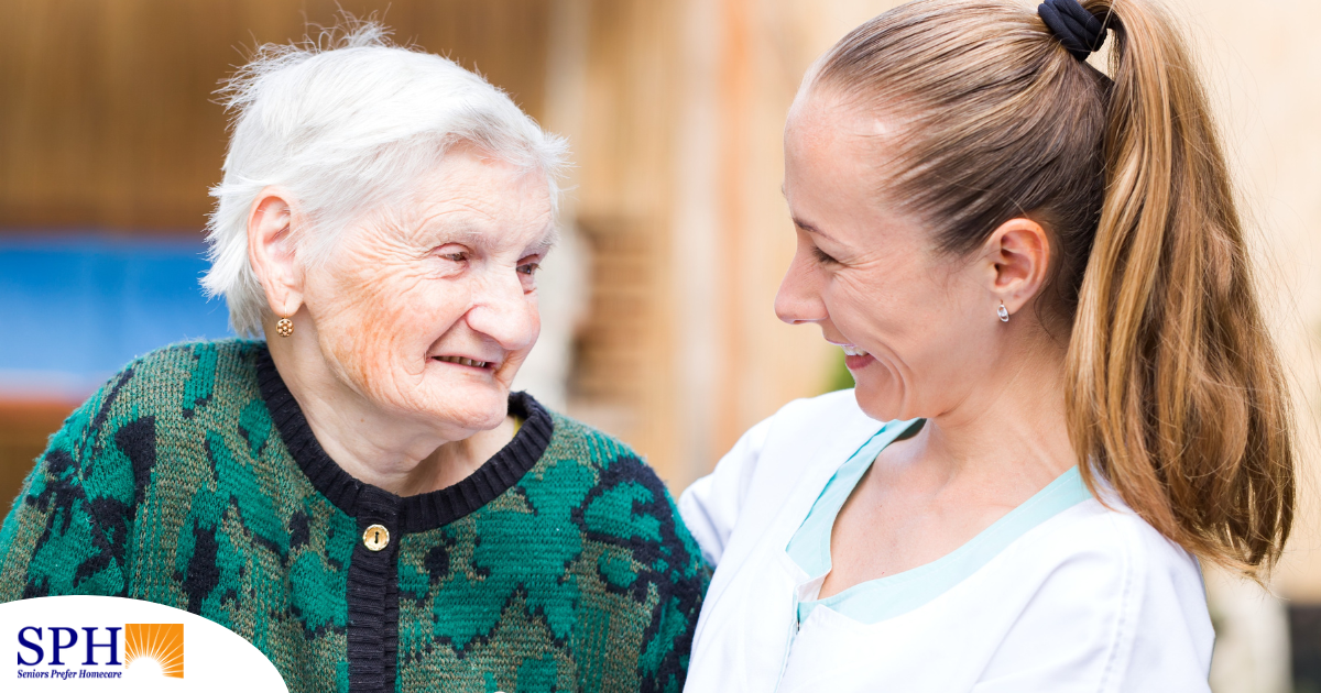 A professional caregiver compassionately hugs a senior client.