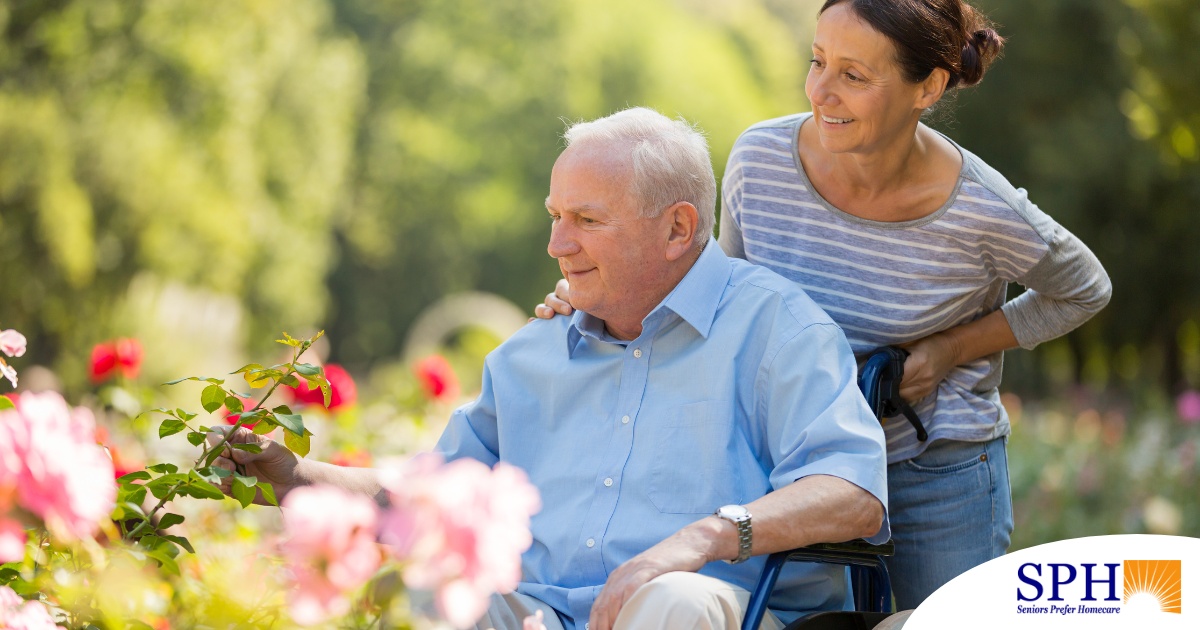 A caregiver takes a senior outside to visit a garden, highlighting one idea for senior activities.