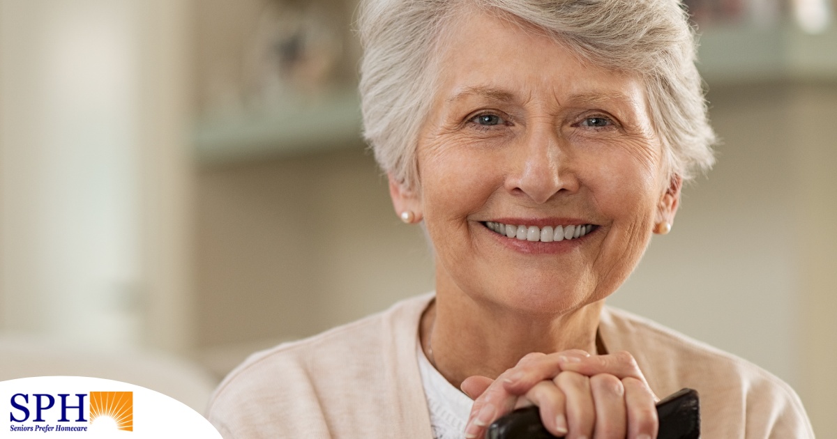 An older woman with healthy teeth smiles, representing good dental hygiene.