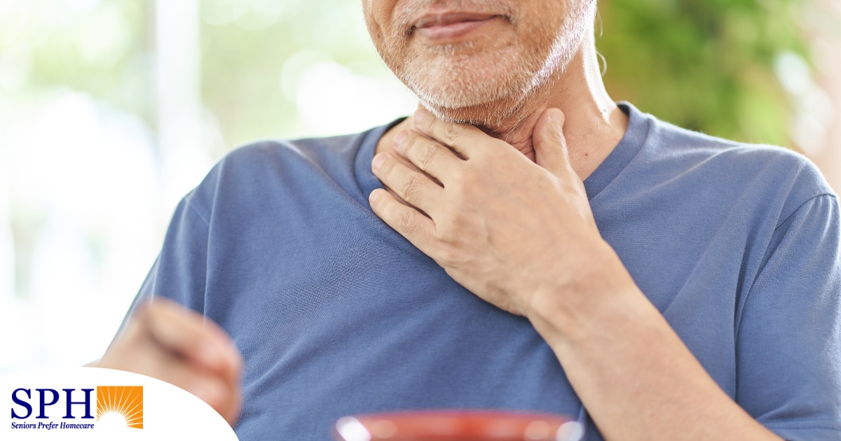 An older adult holds his throat representing dysphagia which can affect senior health.