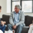 A caregiver talks with an elderly couple representing the kind of communication that professional caregivers need to have to anticipate client needs.