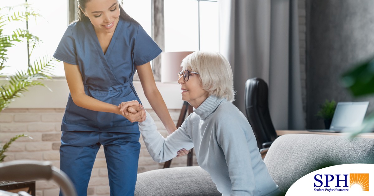 A caregiver demonstrates her caregiver skills by helping an older adult get up.