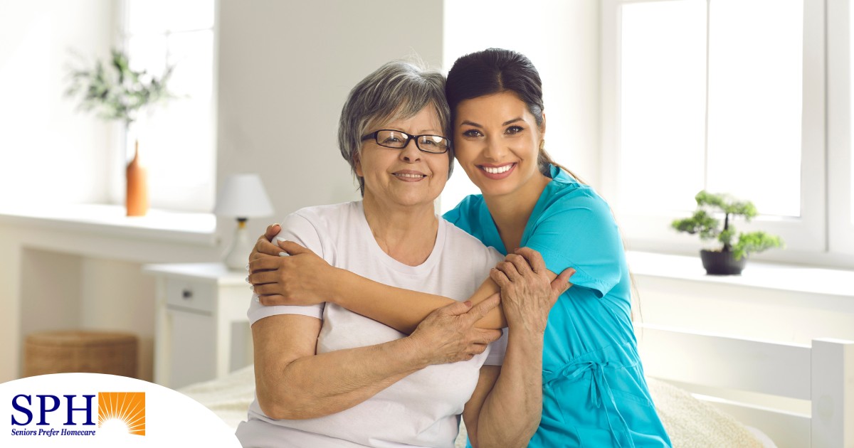 A caregiver hugs an older client, representing how a trustworthy caregiver cares for clients.