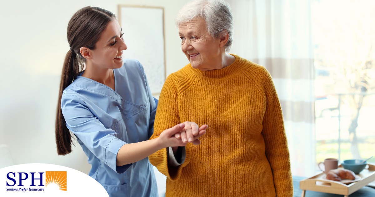 A caregiver helps a client get around, demonstrating one of the job duties of a caregiver.