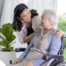 A mother, her daughter, and her mother embrace, representing the sandwich generation.