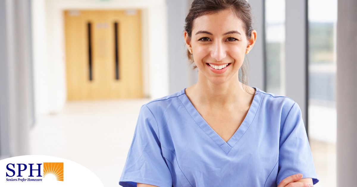 A woman in scrubs smiles, representing the good results that can come when caregivers branch out to become CNAs.