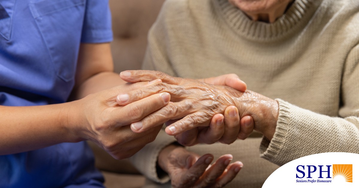 A care provider examines an older adult’s fingers, representing what would happen in an examination for rheumatoid arthritis.
