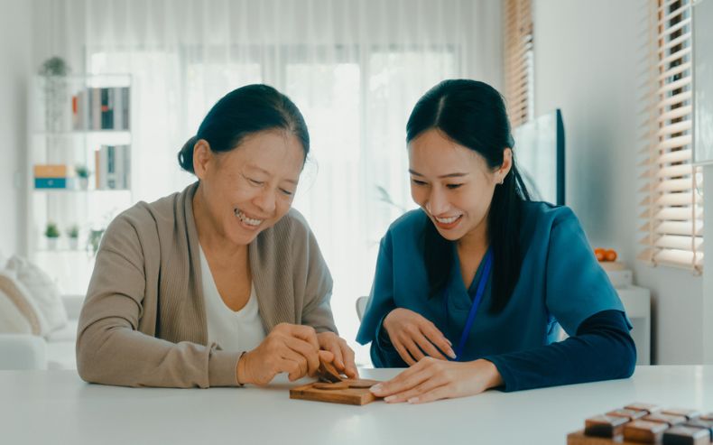 Caregiver engaging a senior in a puzzle activity during Dementia Care in New Hope, AL