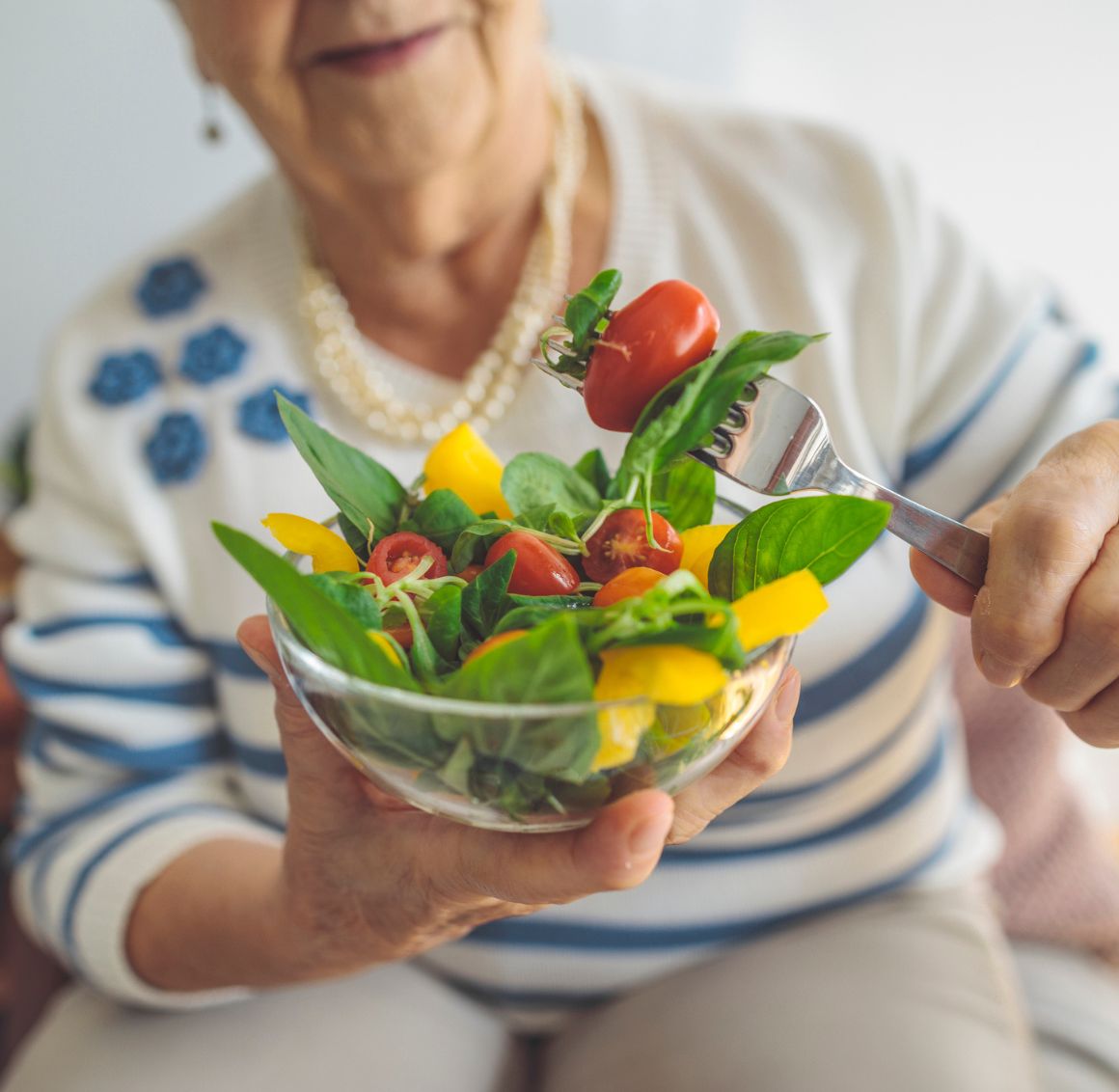 Meal Planning in New Hope Senior woman enjoying a fresh salad at home, reflecting healthy Meal Planning in New Hope for seniors and daily wellness support.